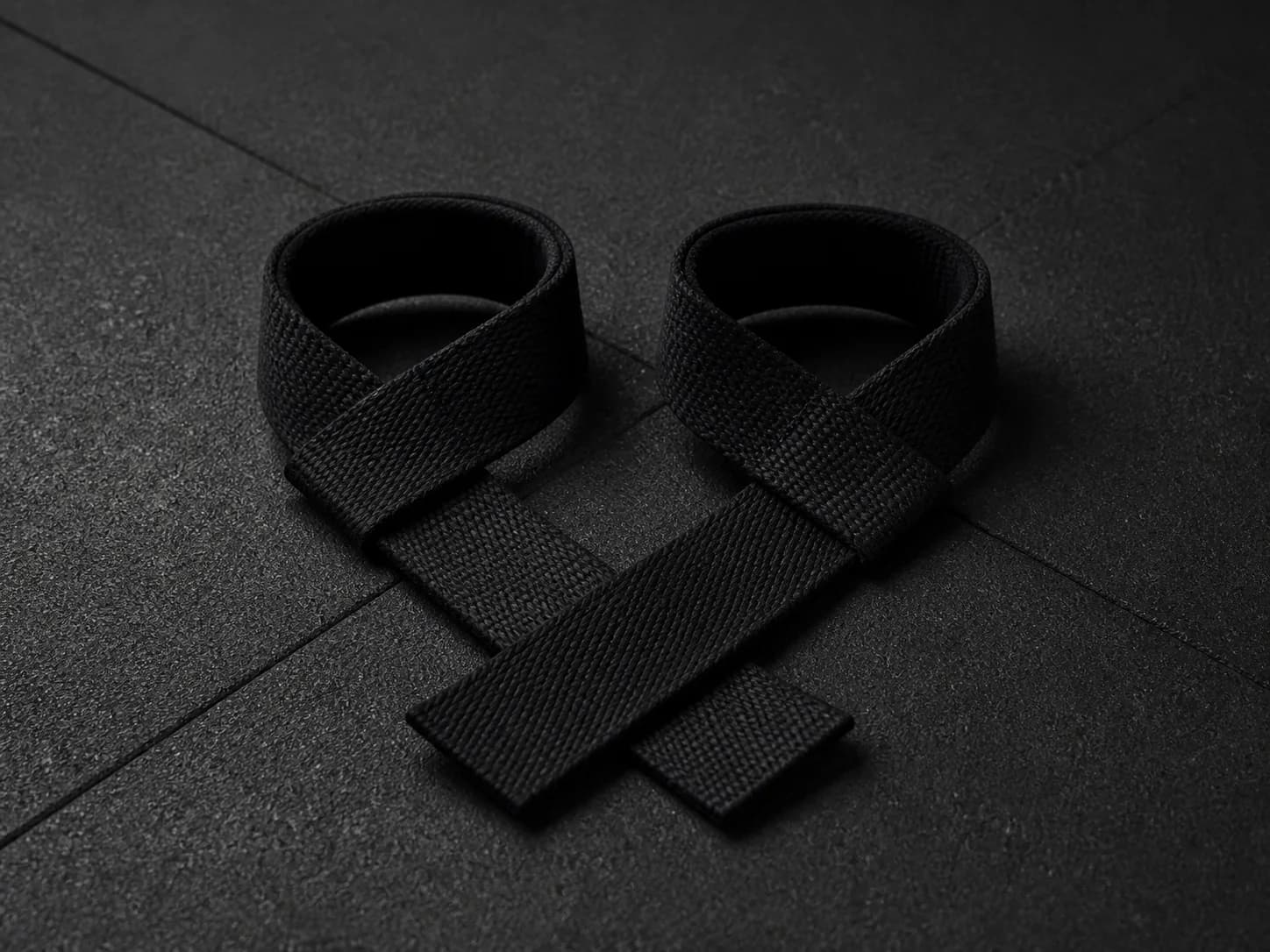 Illustrative product photograph of unbranded black lifting straps